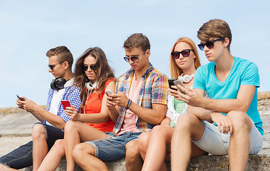 Image showing group of friends with smartphones outdoors