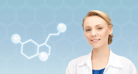 Image showing smiling female doctor with molecule of serotonin
