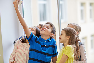 Image showing group of school kids taking selfie with smartphone