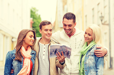 Image showing group of friends with city guide exploring town