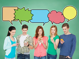 Image showing happy friends showing blank smartphones screens