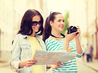 Image showing smiling teenage girls with map