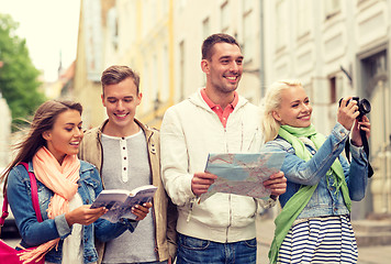 Image showing group of friends with city guide, map and camera