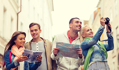 Image showing group of friends with city guide, map and camera