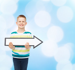 Image showing smiling little boy with blank arrow pointing right