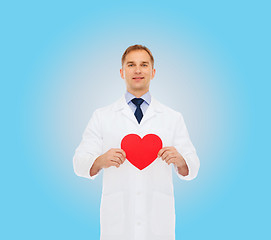 Image showing smiling male doctor with red heart