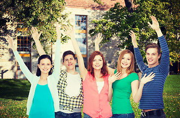 Image showing group of smiling students waving hands