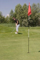 Image showing Female golfer playing golf