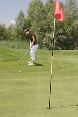 Image showing Female golfer playing golf