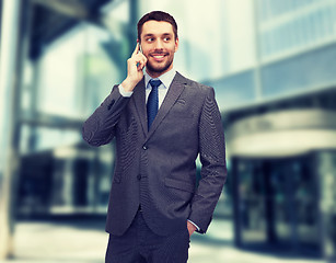 Image showing young smiling businessman with smartphone