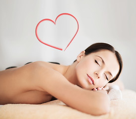 Image showing beautiful woman in spa salon with hot stones