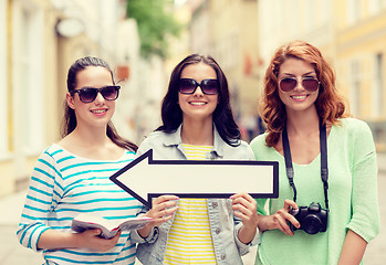 Image showing smiling teenage girls with white arrow outdoors