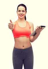 Image showing sporty woman with tablet pc computer