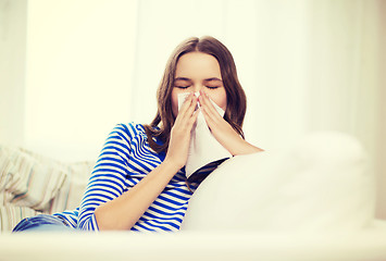 Image showing sick teenage girl with paper tissue