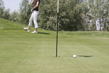 Image showing Female golfer playing golf