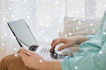 Image showing close up of man working with laptop at home