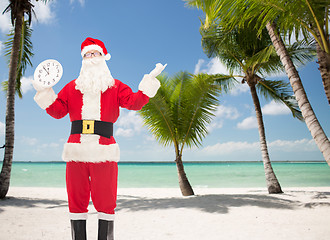 Image showing man in costume of santa claus with clock