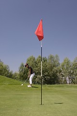 Image showing Female golfer playing golf