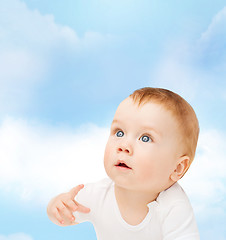 Image showing curious baby looking up