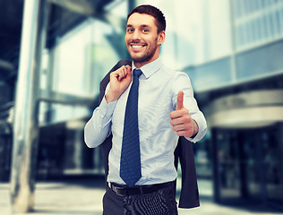 Image showing handsome buisnessman with jacket over shoulder