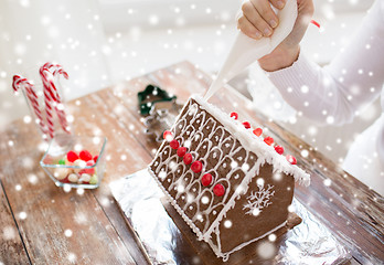 Image showing close up of woman making gingerbread houses