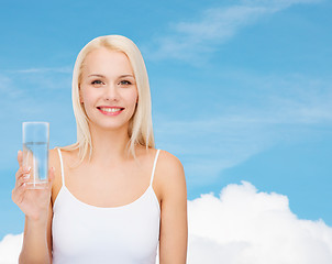 Image showing young smiling woman with glass of water