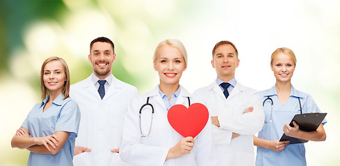 Image showing group of smiling doctors with red heart shape