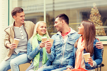 Image showing group of smiling friends with take away coffee