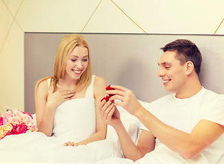 Image showing man giving woman little red box and ring in it