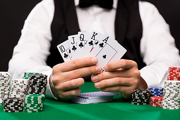 Image showing poker player with cards and chips at casino