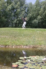 Image showing Female golfer playing golf