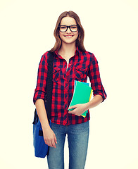 Image showing smiling female student with bag and notebooks