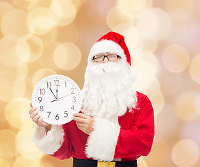 Image showing man in costume of santa claus with clock