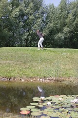 Image showing Female golfer playing golf