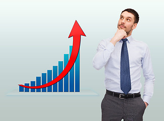 Image showing thinking young businessman with growth chart