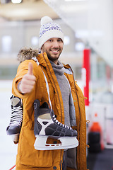 Image showing happy young man showing thumbs up on skating rink