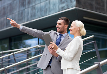 Image showing smiling businessmen with tablet pc outdoors