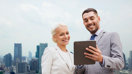 Image showing smiling businessmen with tablet pc in city