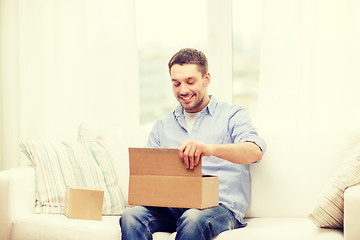 Image showing man with cardboard boxes at home