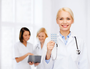 Image showing smiling female doctor with pills