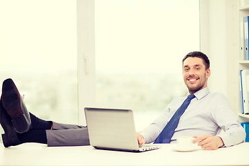 Image showing smiling businessman or student with laptop