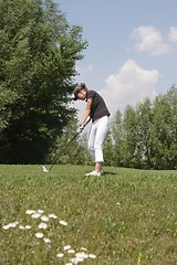 Image showing Female golfer playing golf