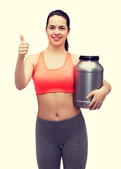 Image showing teenage girl with jar of protein showing thumbs up