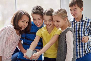 Image showing group of school kids taking selfie with smartphone