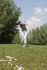 Image showing Female golfer playing golf