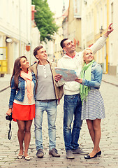 Image showing group of smiling friends with map and photocamera