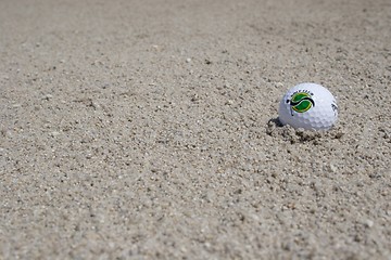 Image showing Golf ball in sand trap