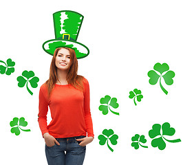 Image showing smiling teen girl in green top hat with shamrock