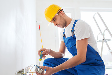 Image showing builder with tablet pc and equipment indoors