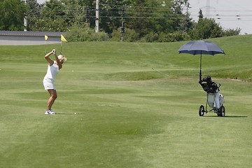 Image showing Female golfer playing golf